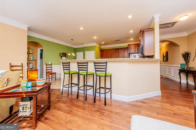 a kitchen with stainless steel appliances granite countertop a stove top oven a sink dishwasher and a refrigerator