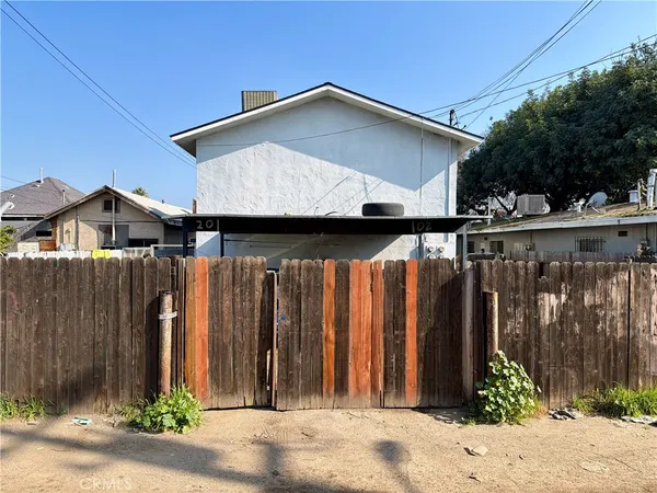 a view of a house with wooden fence