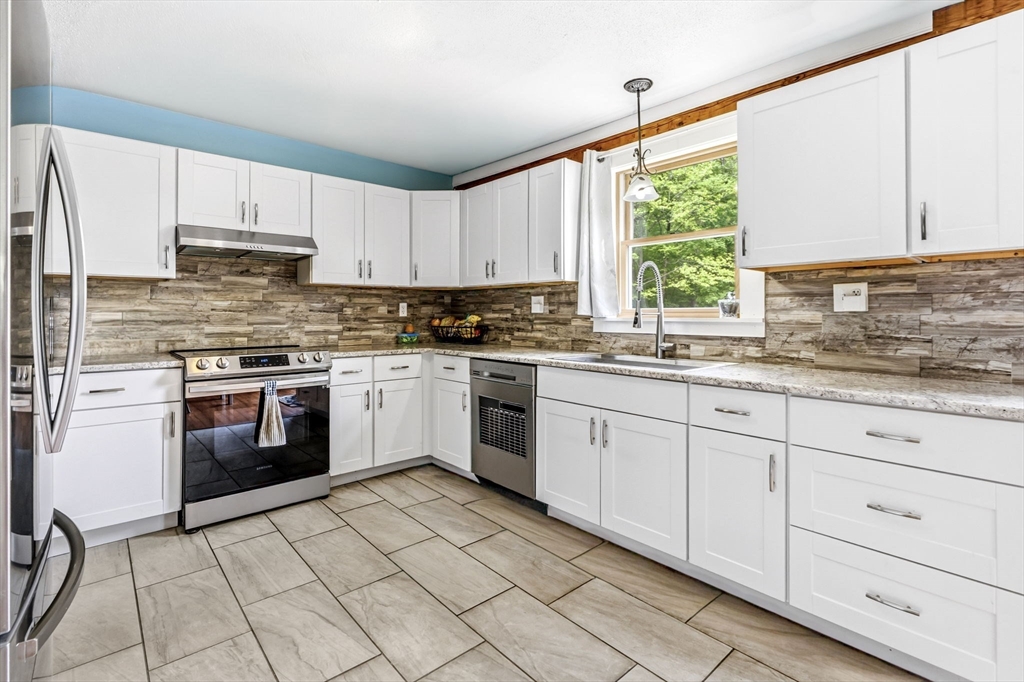 22 Lyon Hill Road Chester, MA 01011 - Photo 14 of 38 a kitchen with a stove sink and cabinets
