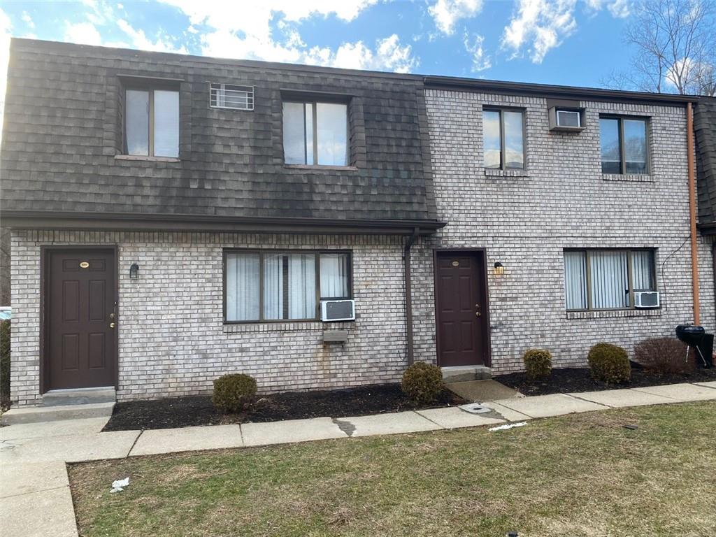 500 Milltown Road, Unit 506 New Kensington, PA 15068 - Photo 2 of 23 a front view of a house with a yard and a garage