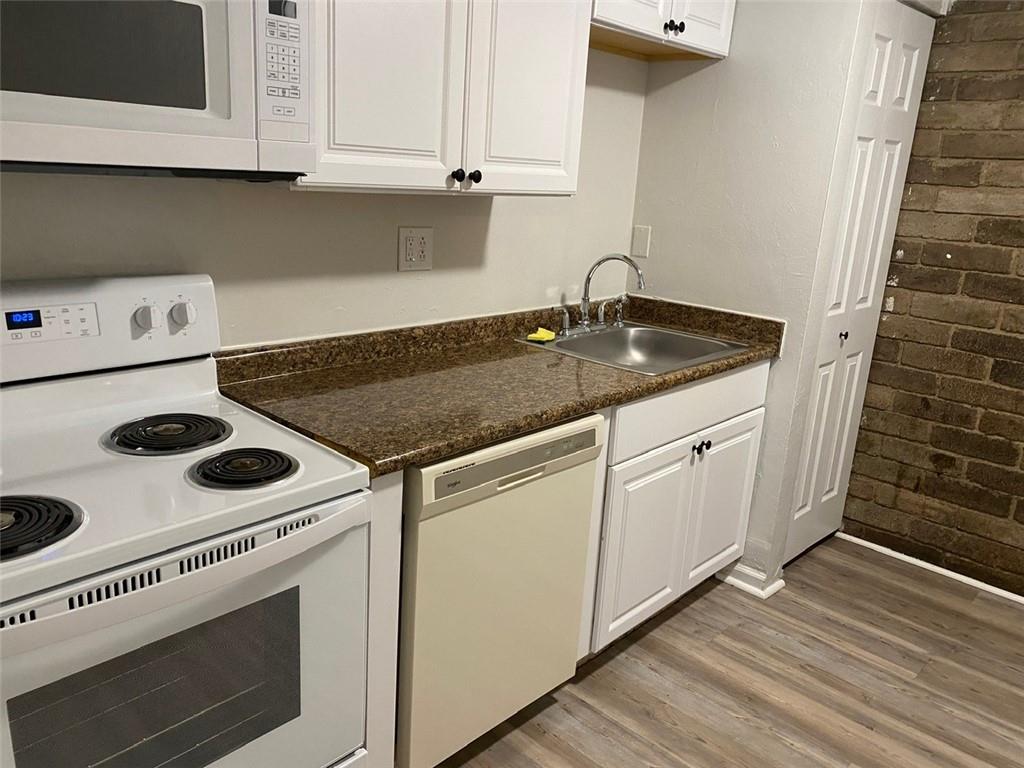 500 Milltown Road, Unit 506 New Kensington, PA 15068 - Photo 10 of 23 a kitchen with a stove and white cabinets