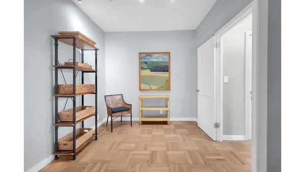 a spacious bedroom with a bed and a lamp
