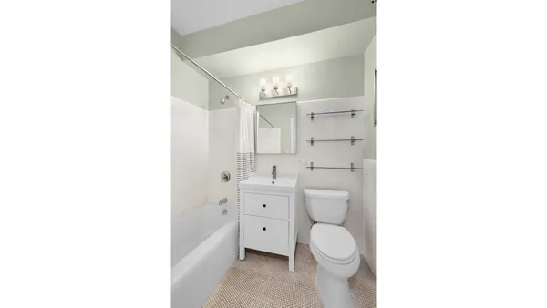 a view of a hallway with furniture and a window