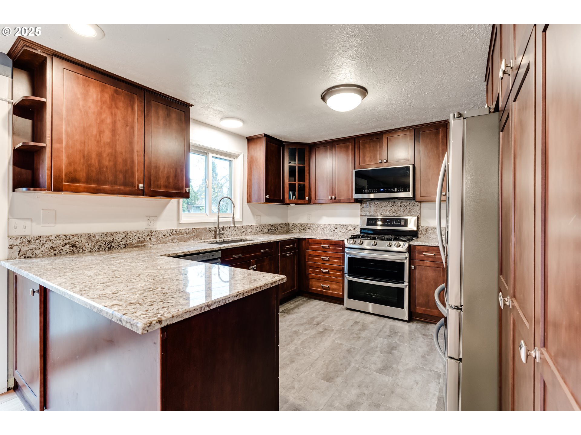2230 Viewmont Avenue Springfield, OR 97477 - Photo 12 of 40 a kitchen with stainless steel appliances granite countertop a refrigerator stove and sink