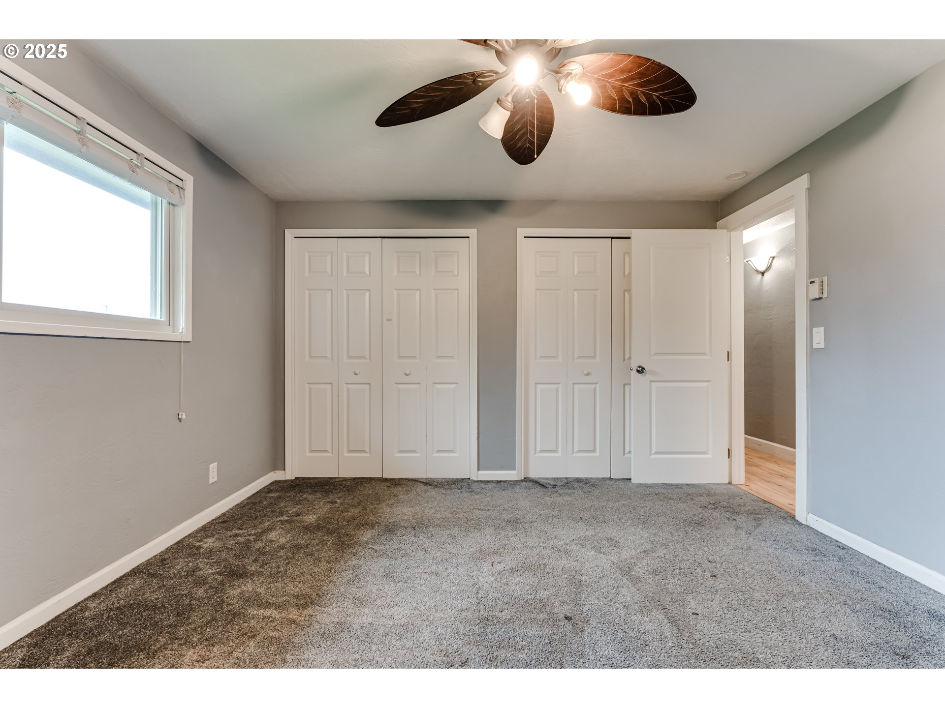 2230 Viewmont Avenue Springfield, OR 97477 - Photo 16 of 40 a view of an empty room with a ceiling fan and window