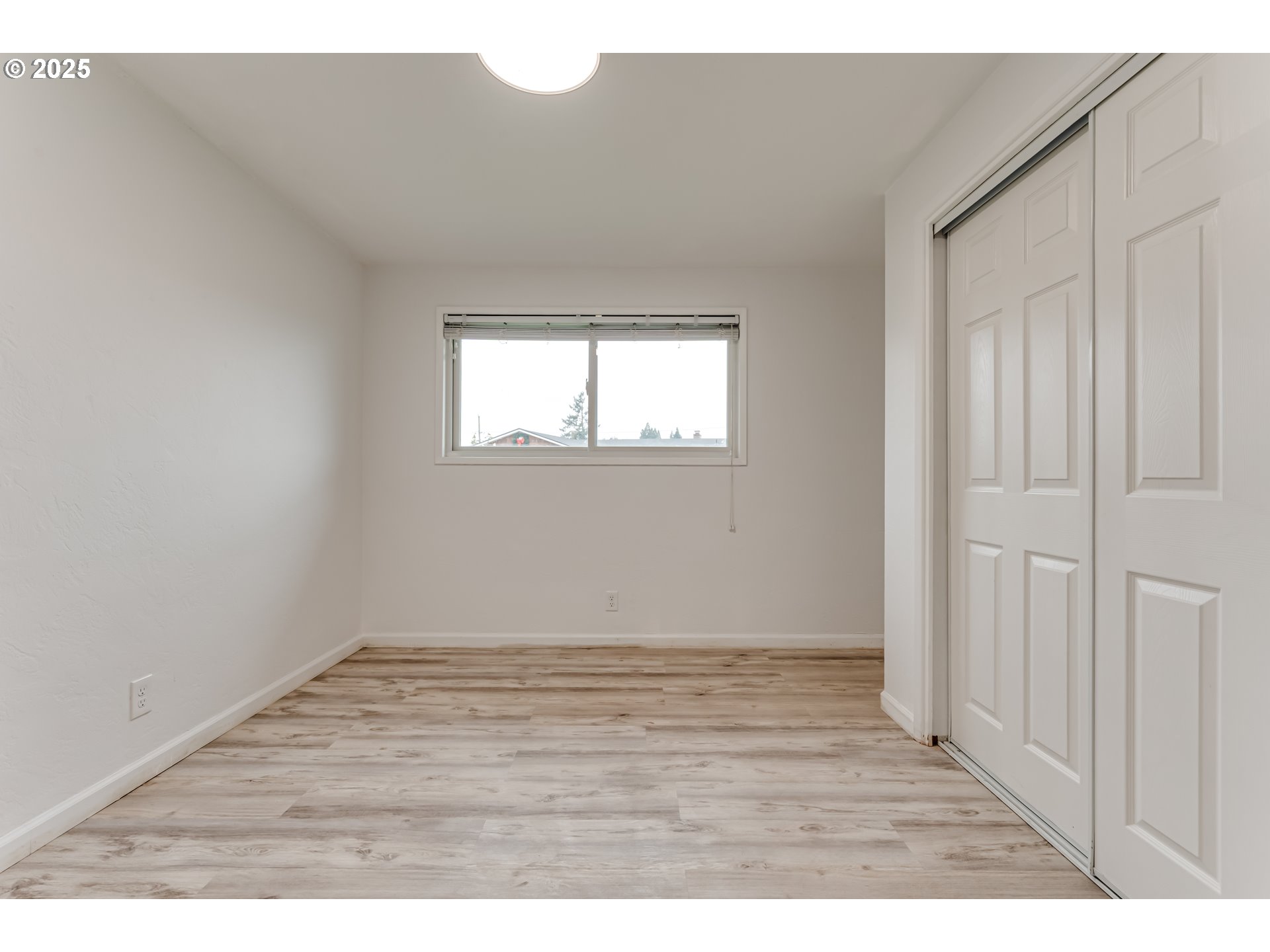 2230 Viewmont Avenue Springfield, OR 97477 - Photo 21 of 40 a view of an empty room with wooden floor and a window