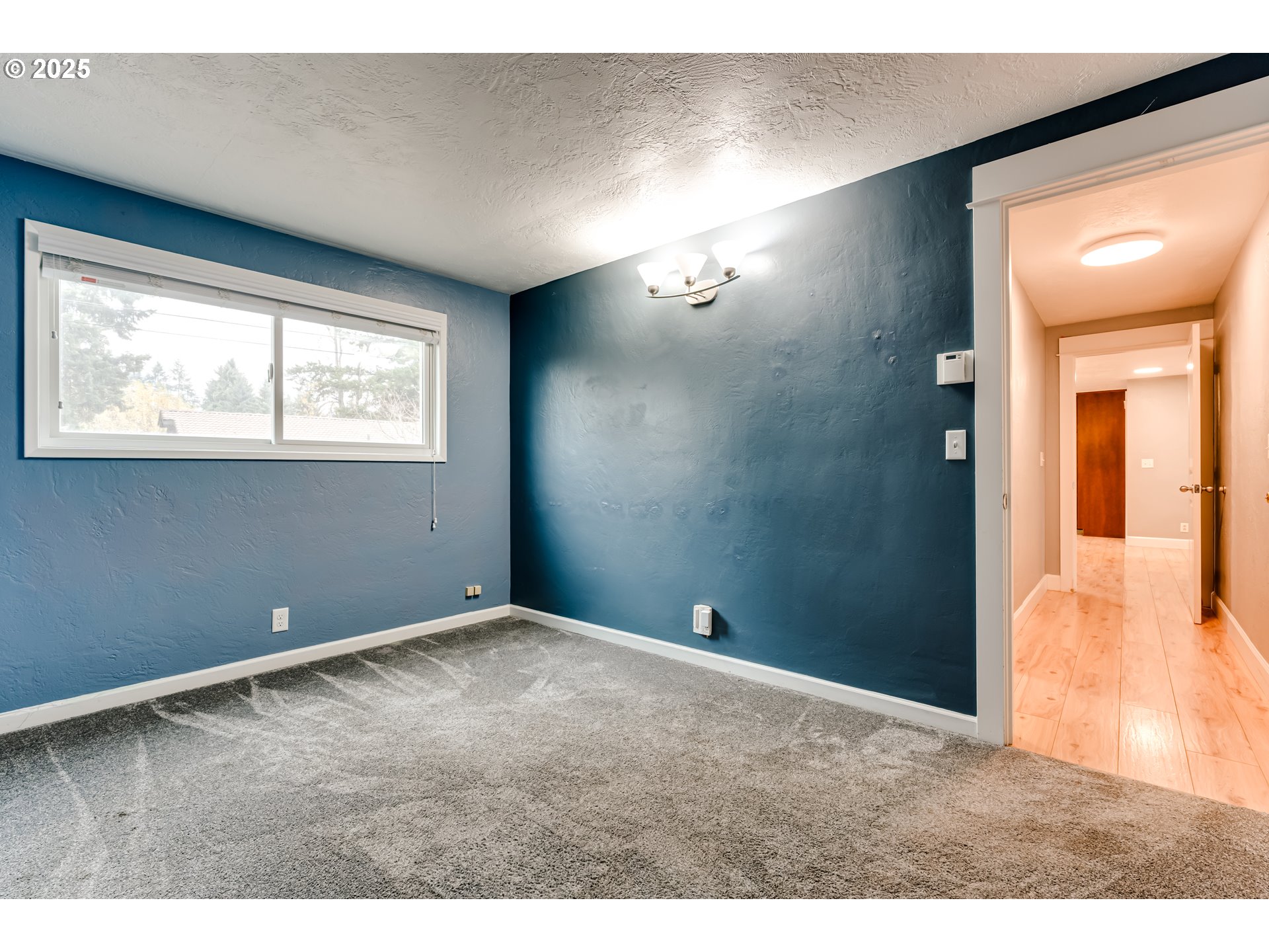 2230 Viewmont Avenue Springfield, OR 97477 - Photo 26 of 40 a view of an empty room with wooden floor and a window