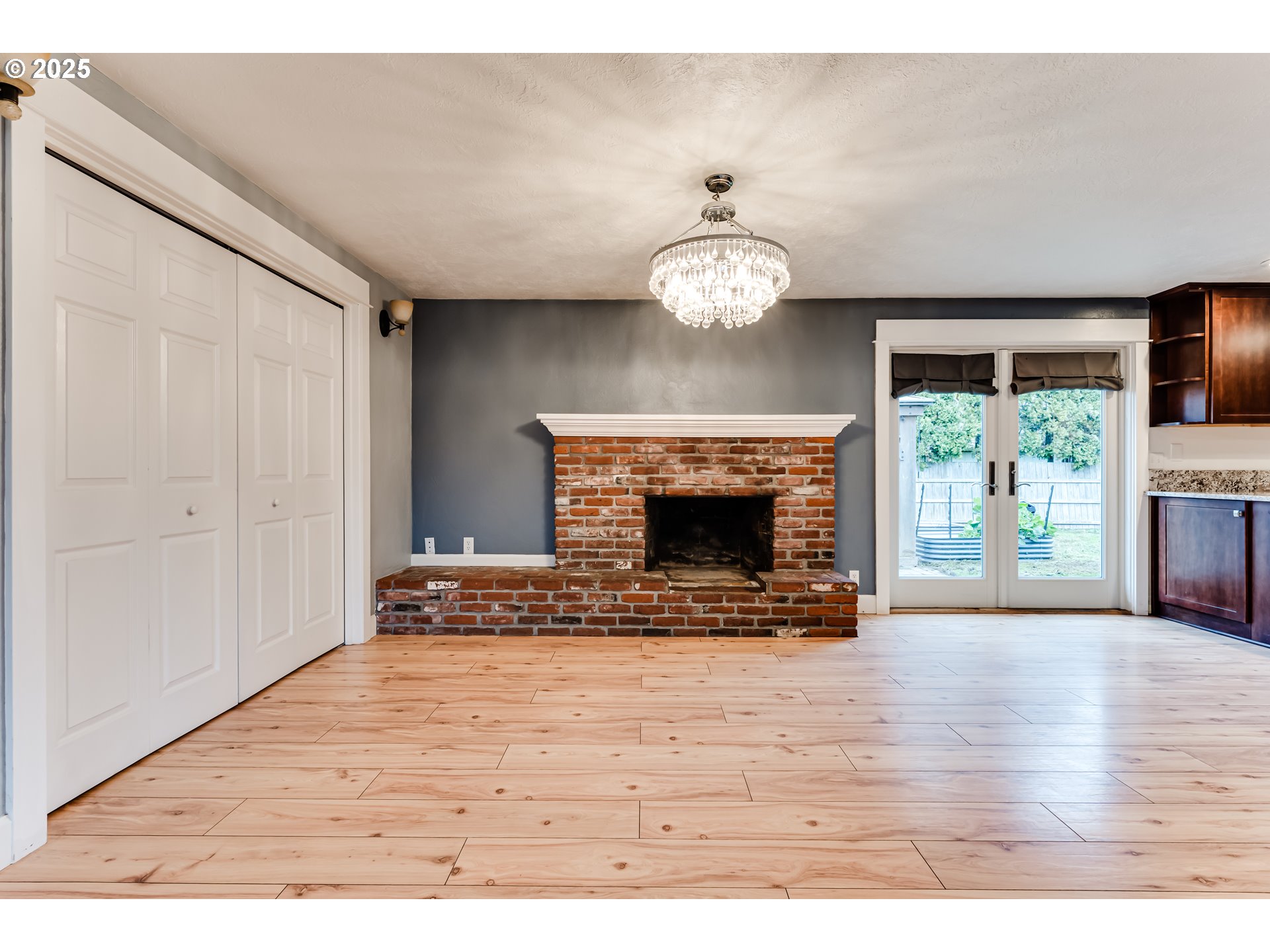 2230 Viewmont Avenue Springfield, OR 97477 - Photo 7 of 40 a view of an empty room with wooden floor fireplace and a window