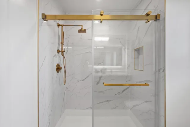 a bathroom with a shower and a bath tub