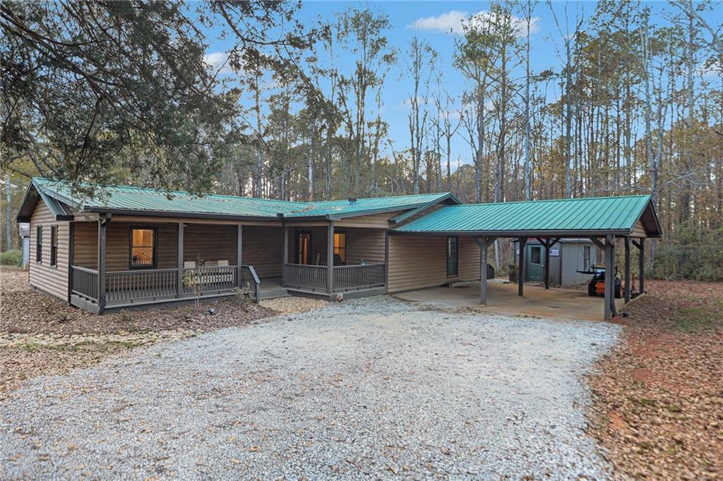 a view of a house with a yard and sitting area