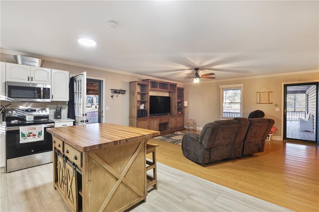 315 Laurel Road Carrollton, GA 30117 - Photo 11 of 30 a living room with stainless steel appliances kitchen island granite countertop furniture and a flat screen tv