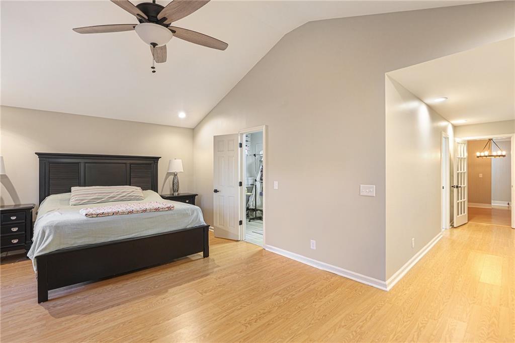 315 Laurel Road Carrollton, GA 30117 - Photo 18 of 30 a bedroom with a bed and a chandelier