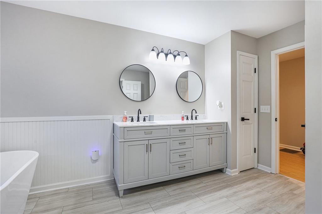 315 Laurel Road Carrollton, GA 30117 - Photo 21 of 30 a bathroom with a double vanity sink and a mirror