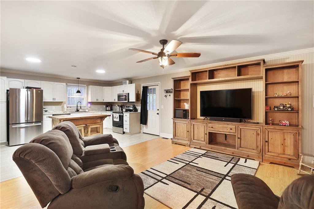 315 Laurel Road Carrollton, GA 30117 - Photo 9 of 30 a living room with furniture and a flat screen tv with kitchen view
