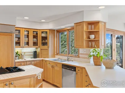 a kitchen with a sink and a large window