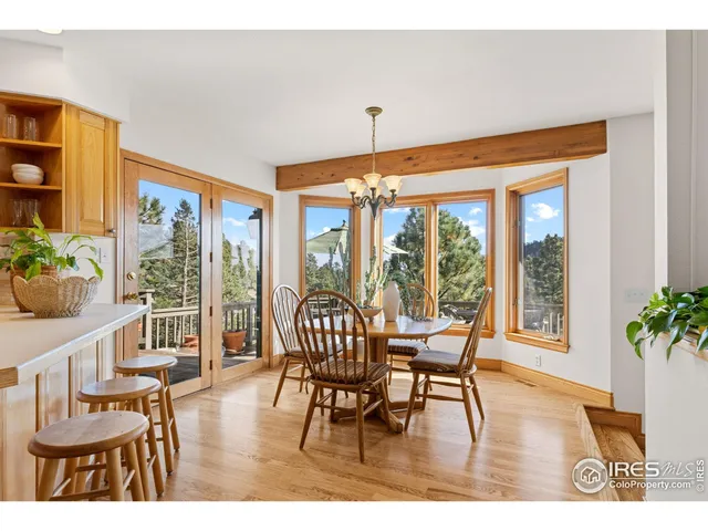 a dining room with furniture window and wooden floor