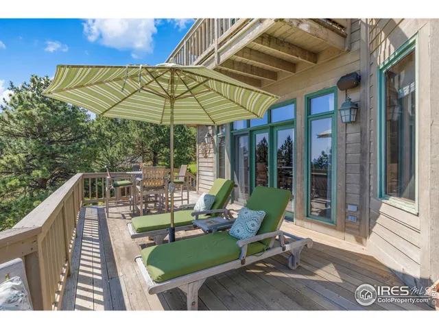 a view of a chairs and table in patio with a small pool