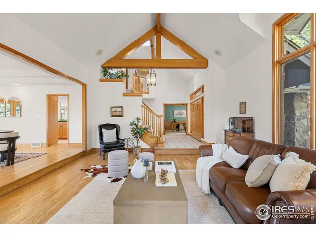 a living room with furniture a fireplace and a large window