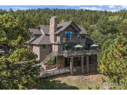 a front view of a house with a yard and mountain view