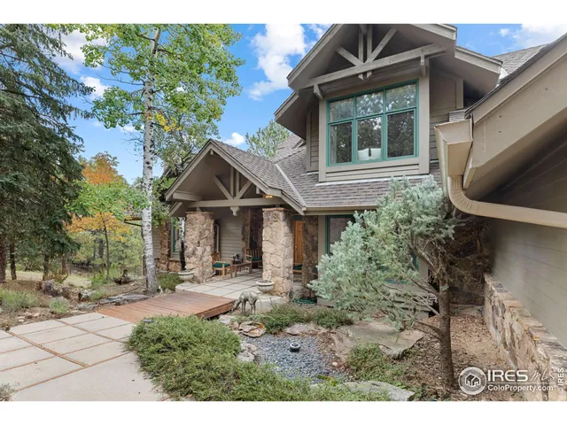 a front view of house with yard and trees around