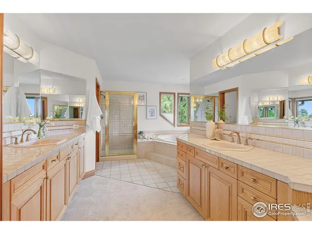 a large bathroom with a granite countertop double vanity and a large mirror