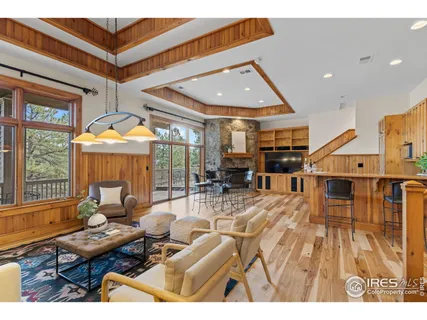 a living room with furniture a wooden floor and a large window