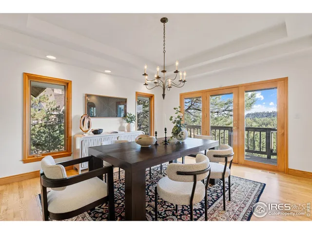 a dining room with furniture a chandelier and wooden floor