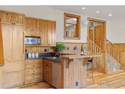 a kitchen with cabinets and wooden floor