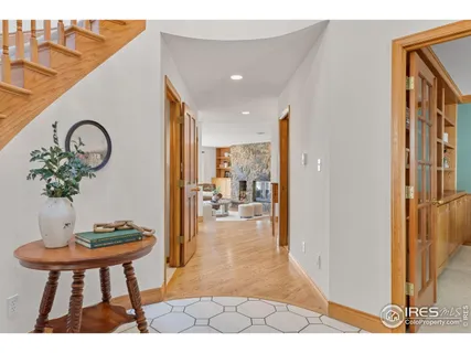 a view of a hallway that has a table and a dining room view