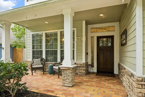 a building outdoor space with patio furniture and potted plants