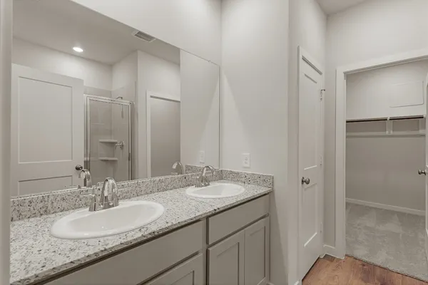 a bathroom with a glass shower door