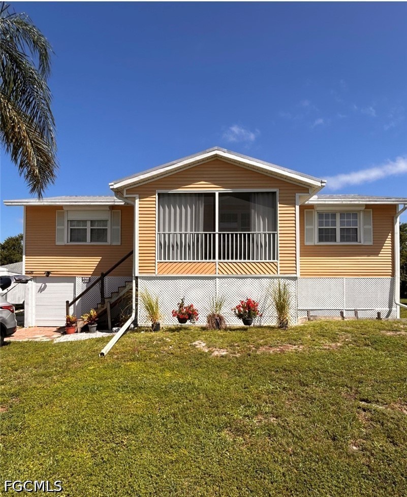 8093 Anhinga Road Fort Myers, FL 33967 - Photo 1 of 49 a front view of a house with a yard