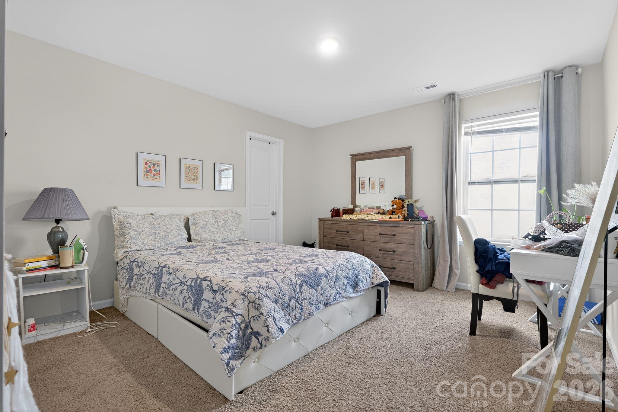 137 North Ranney Way Mooresville, NC 28117 - Photo 20 of 30 a bedroom with a bed and a table in it