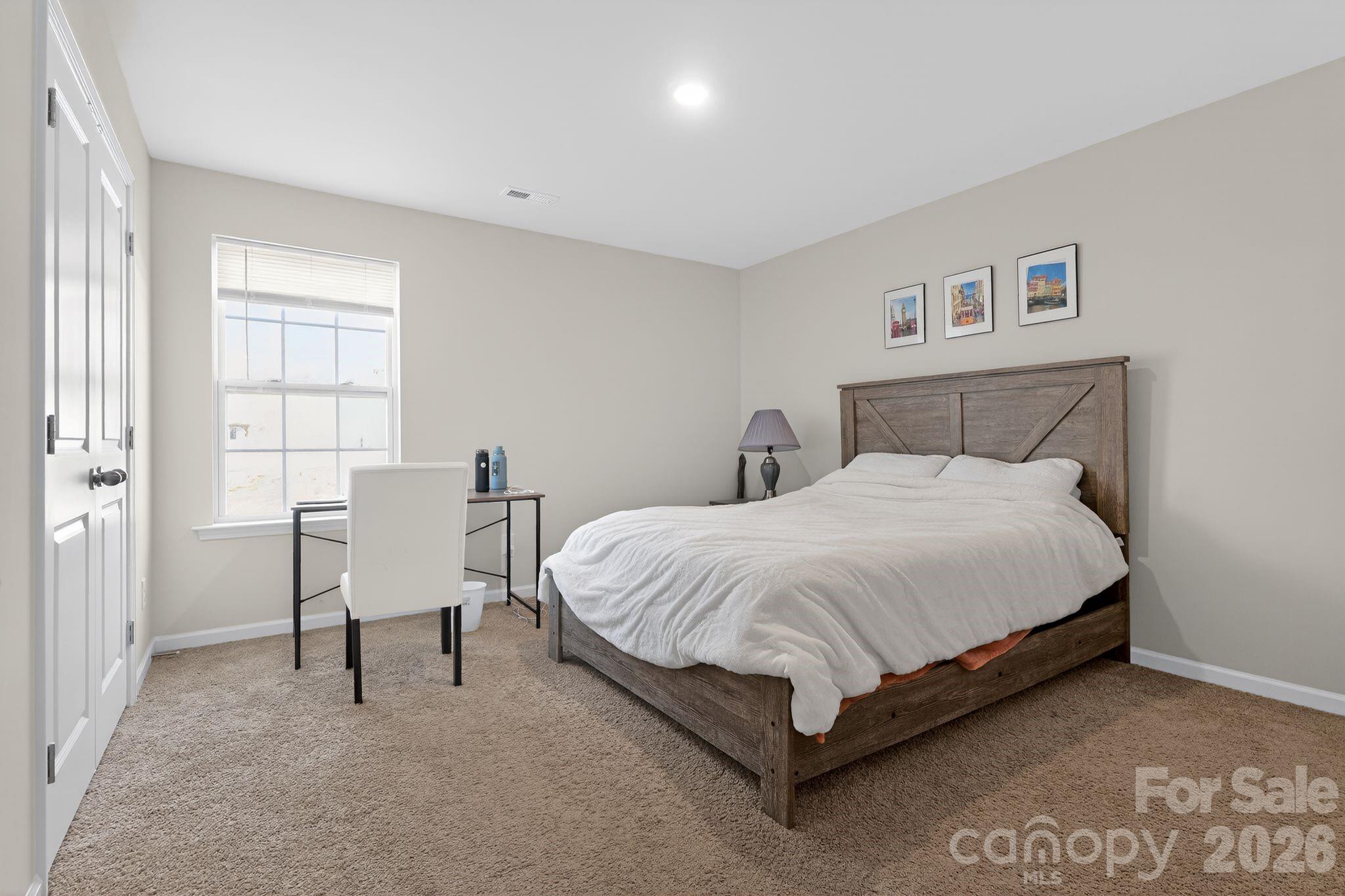 137 North Ranney Way Mooresville, NC 28117 - Photo 24 of 30 a bed sitting in a bedroom next to a window