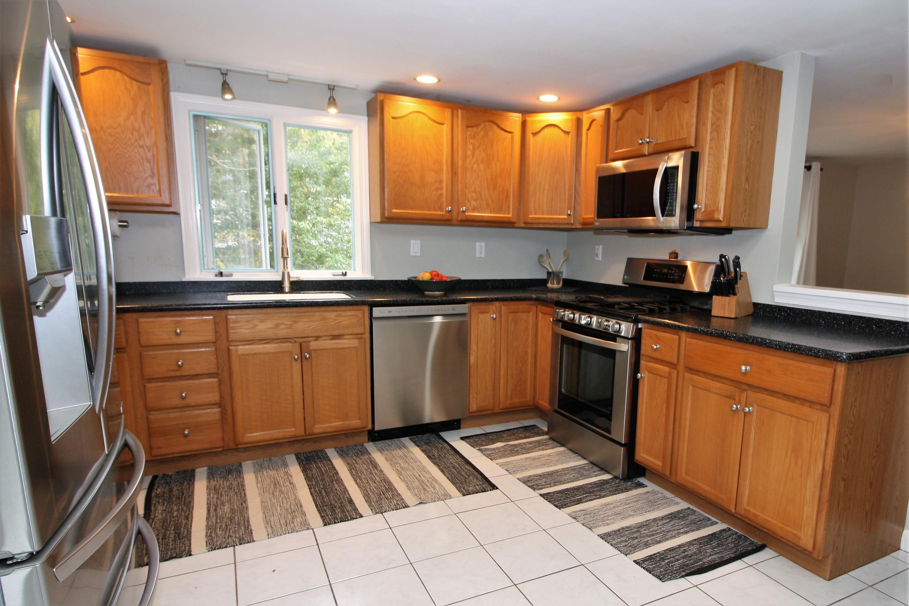 109 Pompano Road Yarmouth Port, MA 02675 - Photo 11 of 42 a kitchen with a sink a stove cabinets and wooden floor