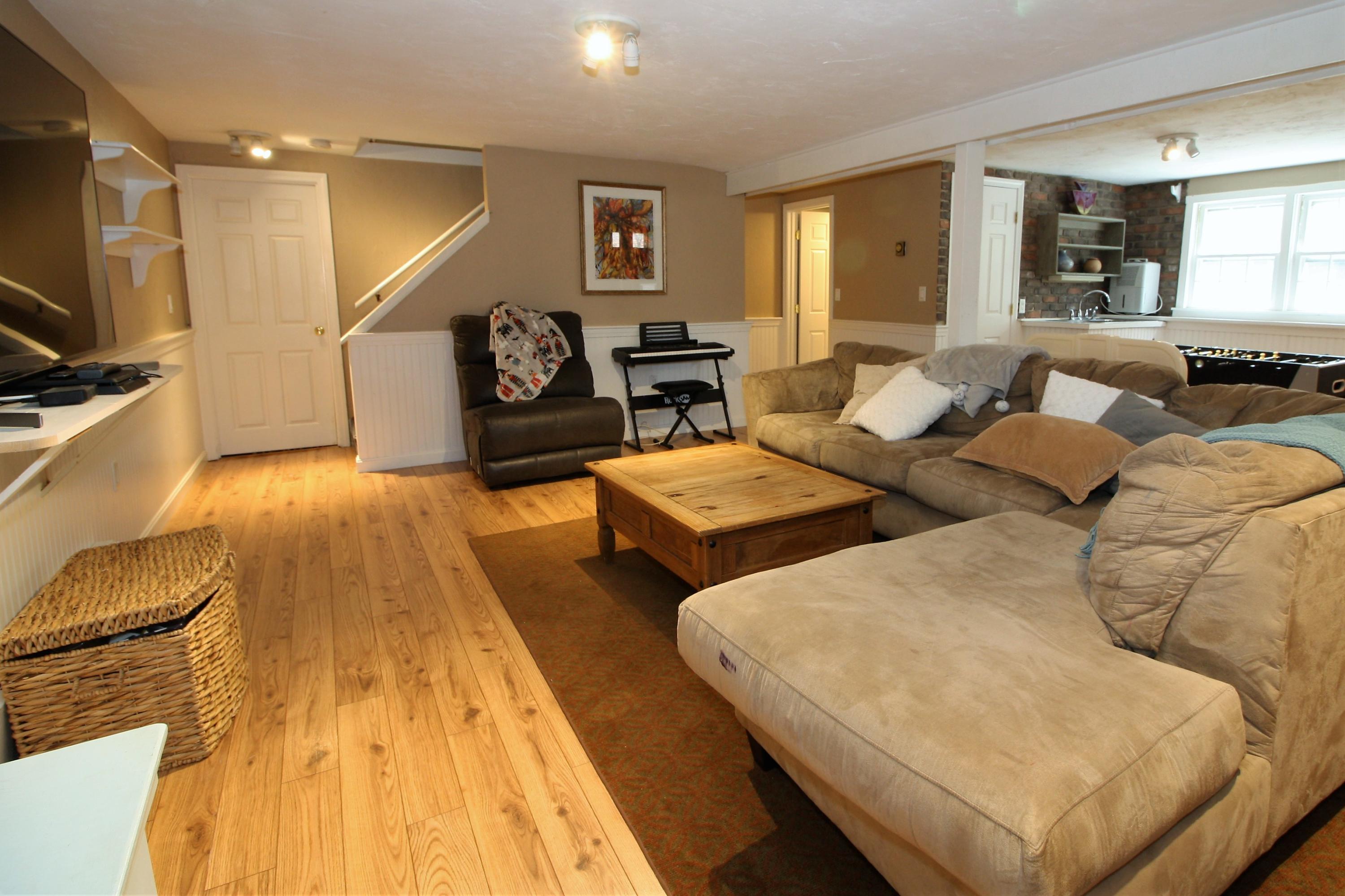 109 Pompano Road Yarmouth Port, MA 02675 - Photo 26 of 42 a living room with couches and kitchen view with wooden floor