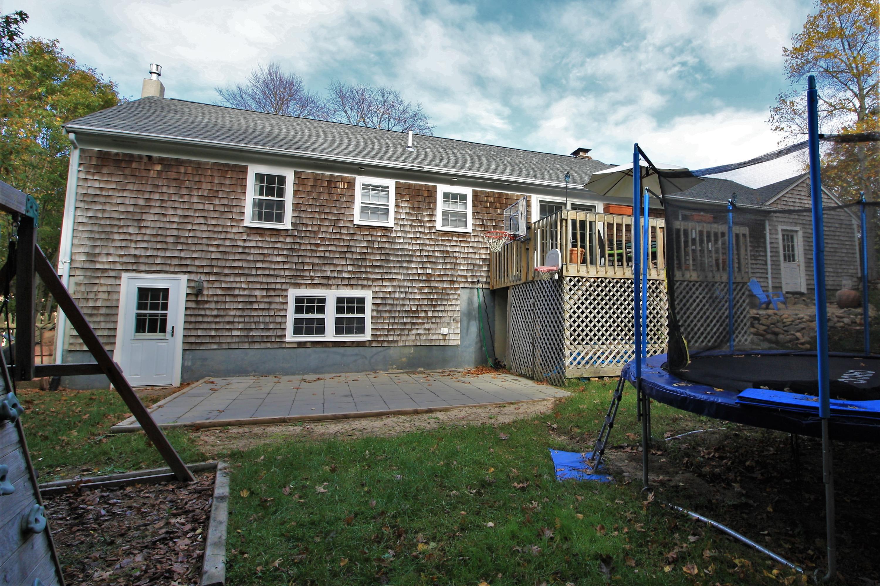 109 Pompano Road Yarmouth Port, MA 02675 - Photo 37 of 42 a backyard of a house with barbeque oven table and chairs