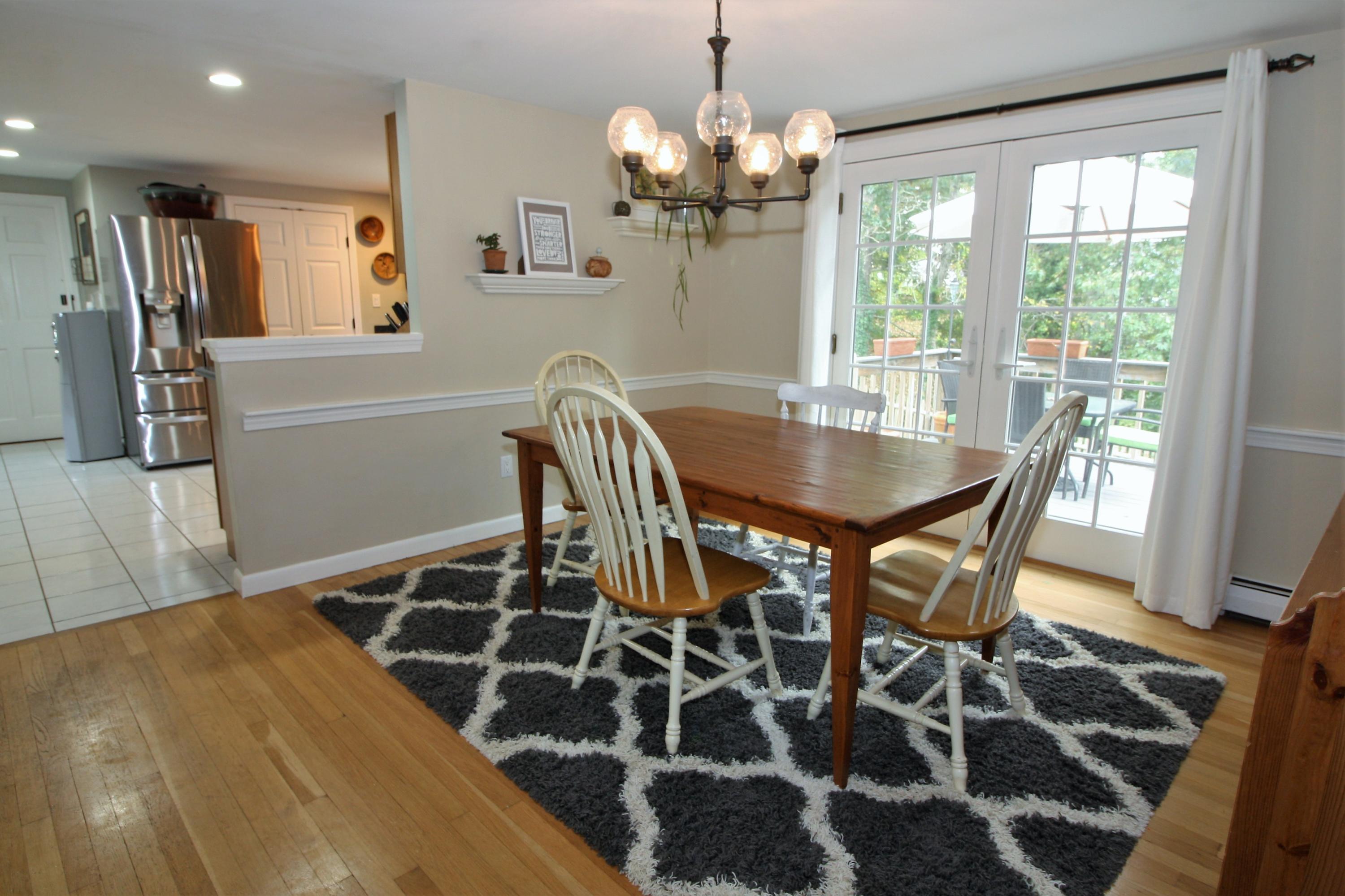 109 Pompano Road Yarmouth Port, MA 02675 - Photo 7 of 42 a view of a dining room with furniture and wooden floor
