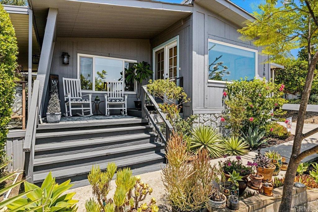 18218 Paradise Mountain Road, Unit 116 Valley Center, CA 92082 - Photo 4 of 35 a view of a house with a flower garden