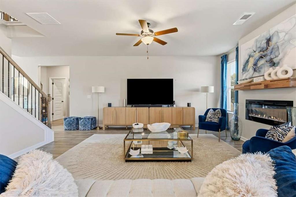 1171 Bodega Loop Locust Grove, GA 30248 - Photo 11 of 57 a living room with furniture flat screen tv and a fireplace