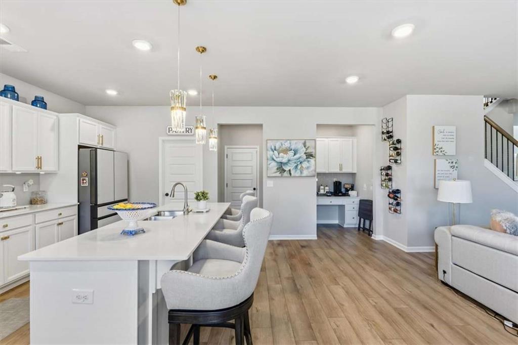 1171 Bodega Loop Locust Grove, GA 30248 - Photo 16 of 57 a large kitchen with sink a refrigerator and chairs
