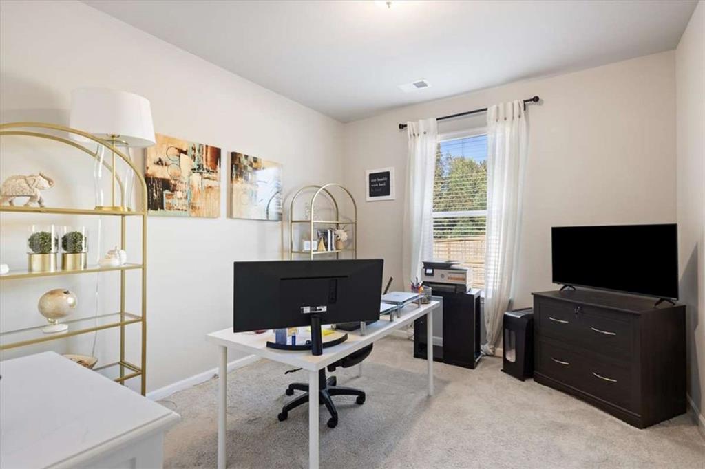 1171 Bodega Loop Locust Grove, GA 30248 - Photo 20 of 57 a view of a livingroom with workspace and a window