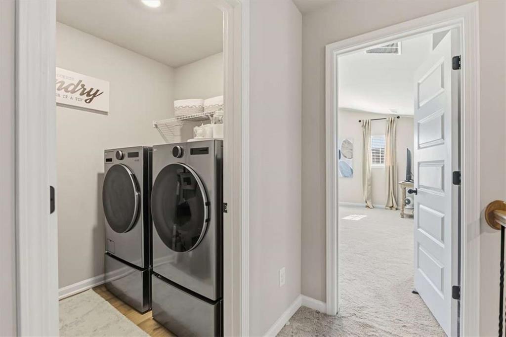 1171 Bodega Loop Locust Grove, GA 30248 - Photo 21 of 57 a view of a hallway with washer and dryer