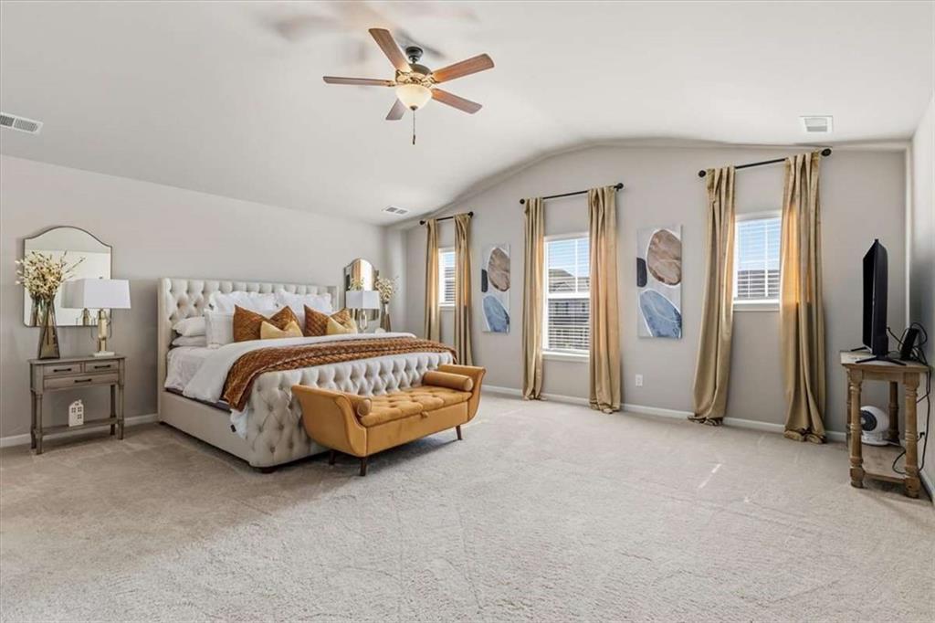 1171 Bodega Loop Locust Grove, GA 30248 - Photo 22 of 57 a bedroom with a bed a chandelier and dresser