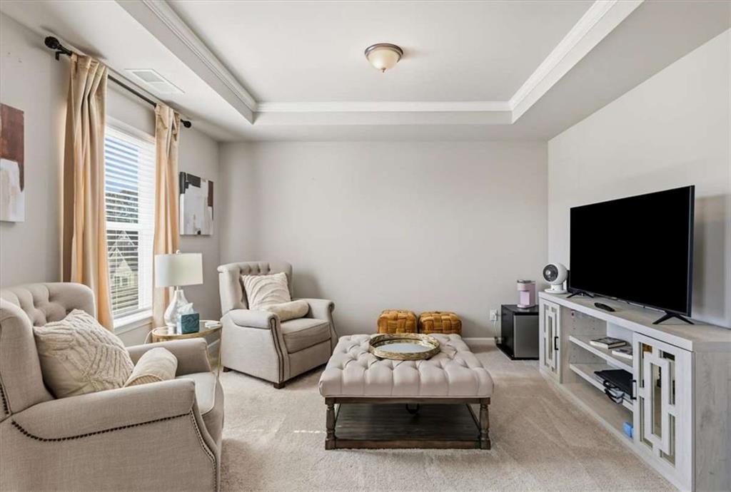 1171 Bodega Loop Locust Grove, GA 30248 - Photo 26 of 57 a living room with furniture and a flat screen tv
