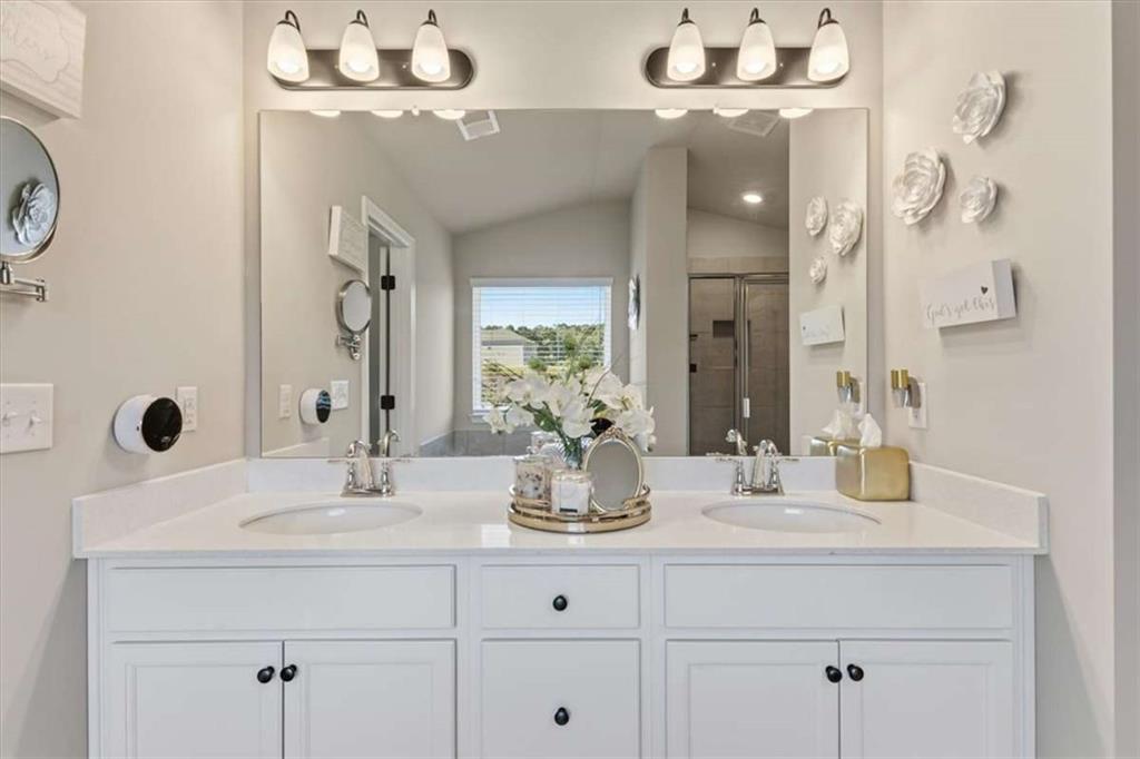 1171 Bodega Loop Locust Grove, GA 30248 - Photo 29 of 57 a bathroom with double vanity sinks a vanity and a mirror