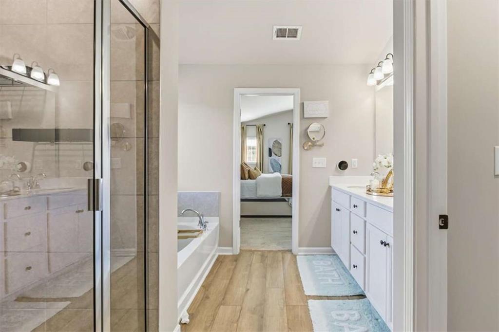 1171 Bodega Loop Locust Grove, GA 30248 - Photo 31 of 57 a bathroom with a glass door shower a sink and a mirror