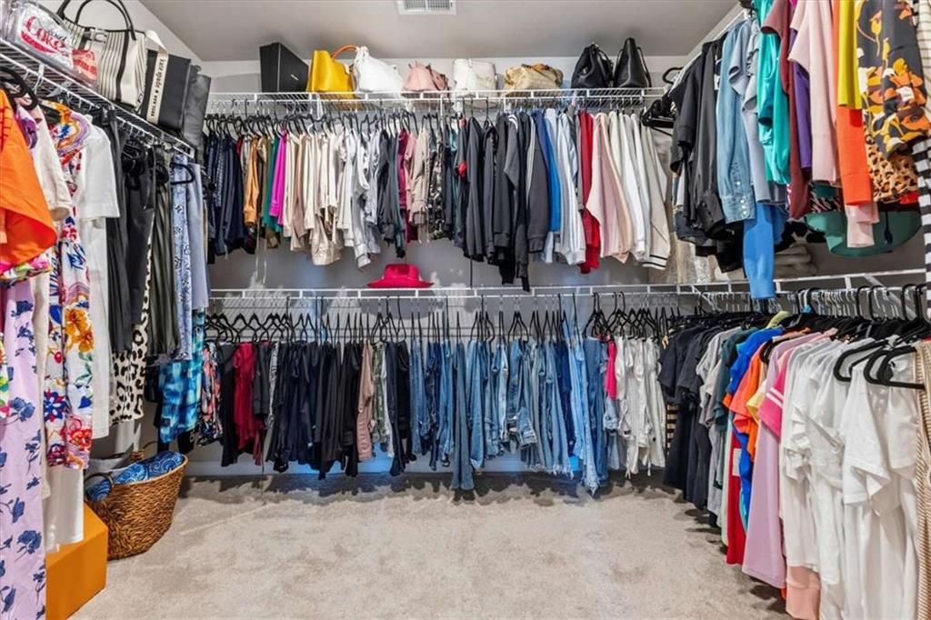 1171 Bodega Loop Locust Grove, GA 30248 - Photo 32 of 57 a view of walk in closet with clothes