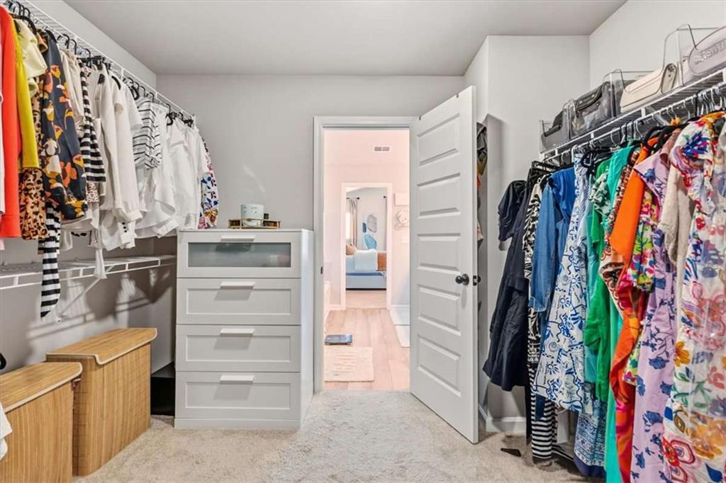 1171 Bodega Loop Locust Grove, GA 30248 - Photo 33 of 57 a view of walk in closet with clothes and shoes