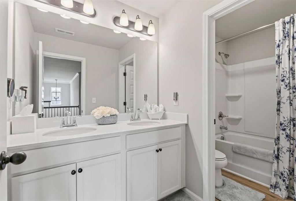 1171 Bodega Loop Locust Grove, GA 30248 - Photo 38 of 57 a bathroom with a granite countertop sink and a mirror